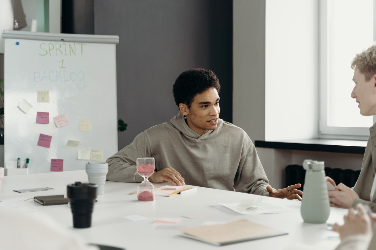 A diverse team engages in a productive office meeting, planning a project with teamwork and collaboration.